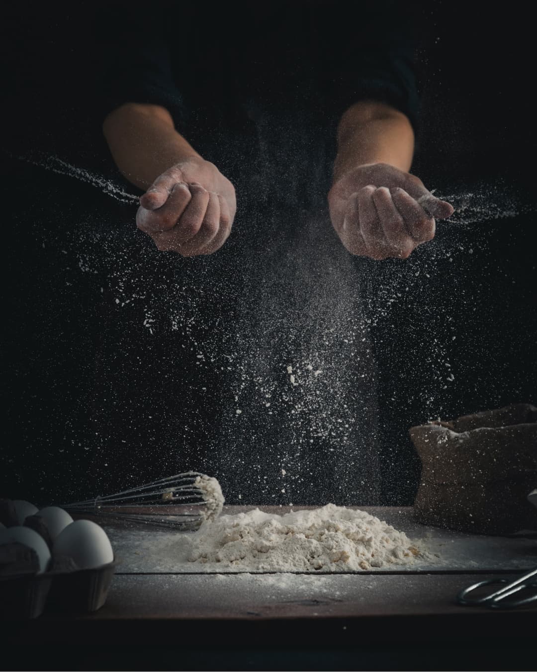 A chef preparing dough in a professional kitchen